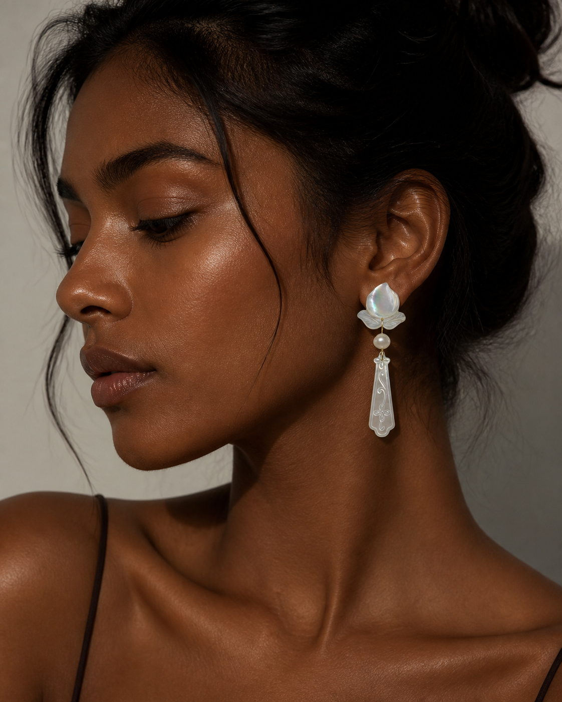 Side profile of a bride wearing the iridescent mother of pearl drop earrings, showcasing the elegant dangle on her wedding day.