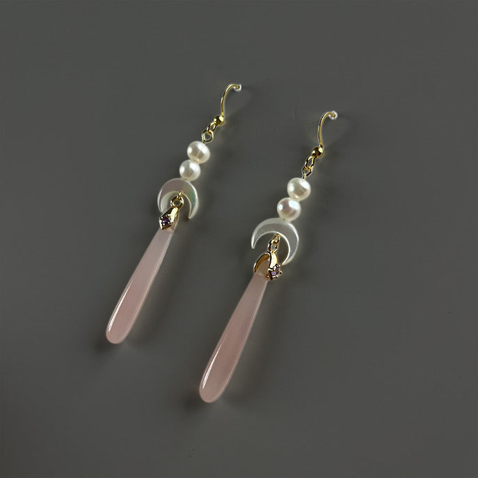 Handcrafted celestial-inspired wedding earrings with hand-carved mother of pearl moons and elegant pink agate drop pendants.

