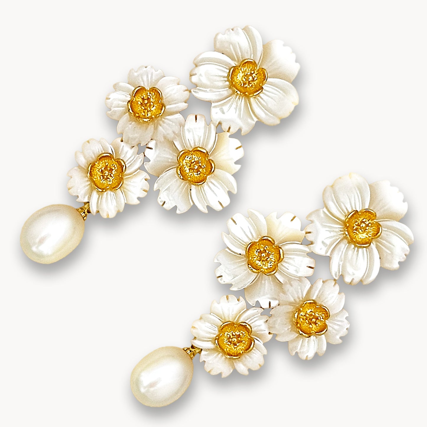 Elegant floral bouquet dangle earrings with yellow centers and pearls isolated on white background
