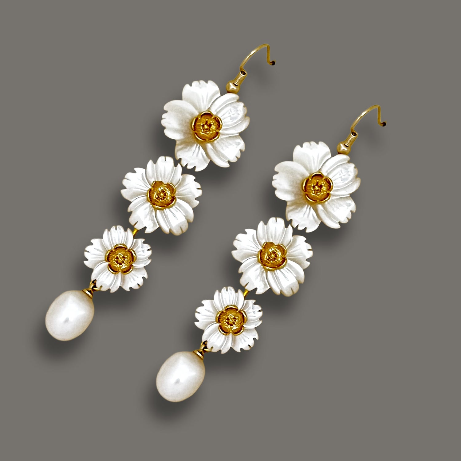 Handcrafted long mother-of-pearl floral drop earrings with a teardrop pearl finish.