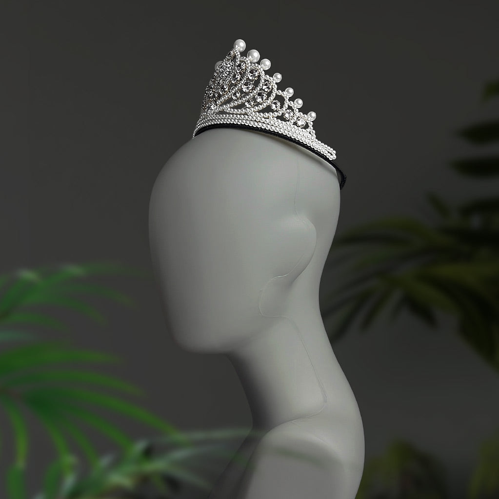 Angled view of a handmade pearl and crystal bridal headpiece showing intricate structural design. 