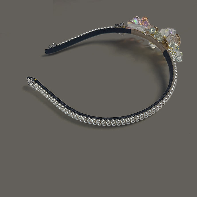 Top view of the handcrafted bridal crown showcasing its elegant curve and luminous pearl embellishments.