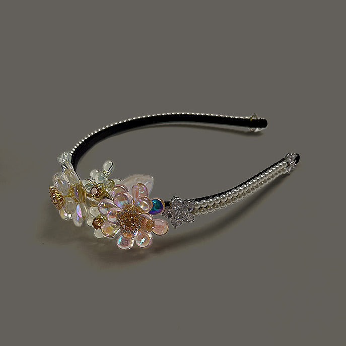 Side view of romantic wedding headpiece showing intricate hand-wired Liuli flowers and sparkling zircon.
