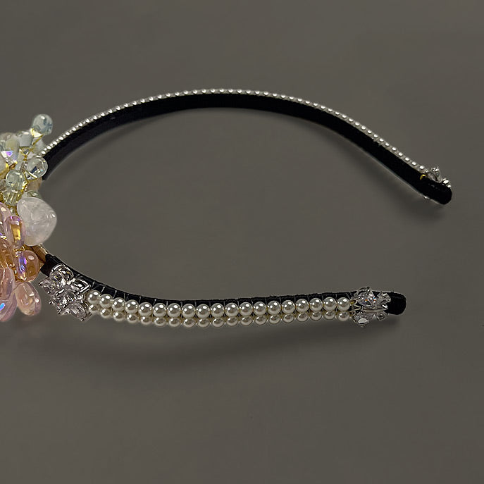 Close up detail of the elegant pearl-wrapped band on the handcrafted bridal hair accessory.