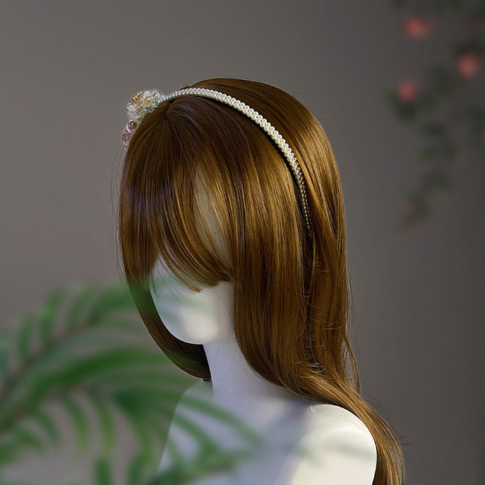 Bride wearing the romantic pearl and zircon floral hairpiece, showing how it elegantly frames the face.