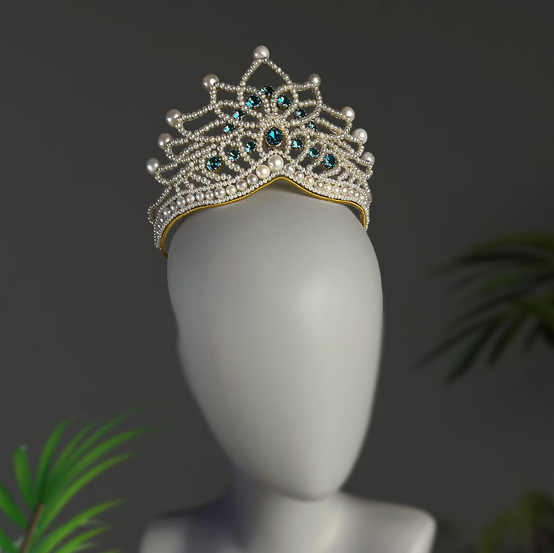 Statement bridal hair accessory with blue zircon stones and pearls on a mannequin head, demonstrating how it sits perfectly for wedding hairstyles.
