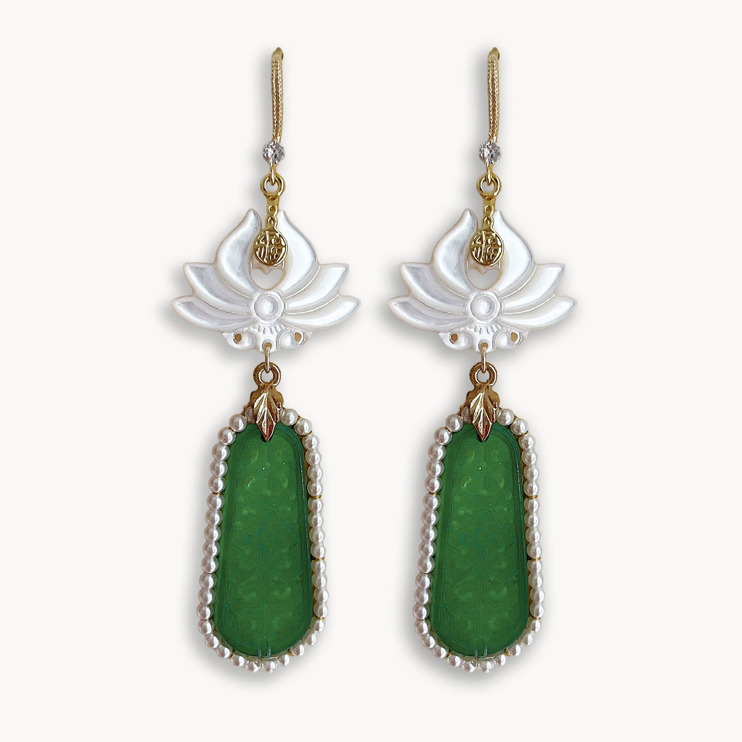 legant handcrafted white flower and green geometric dangle earrings isolated on pure white background